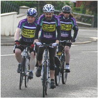 Bill, Andrew and Ernie Arthur looking determined as they cycle up to St Andrew's, Glencairn, on Tuesday morning.